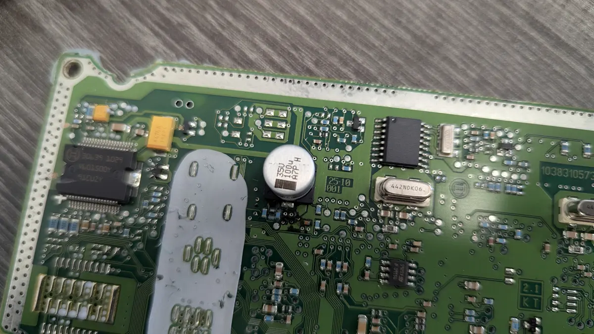 Automotive ECU circuit board under repair at the Zidra workstation